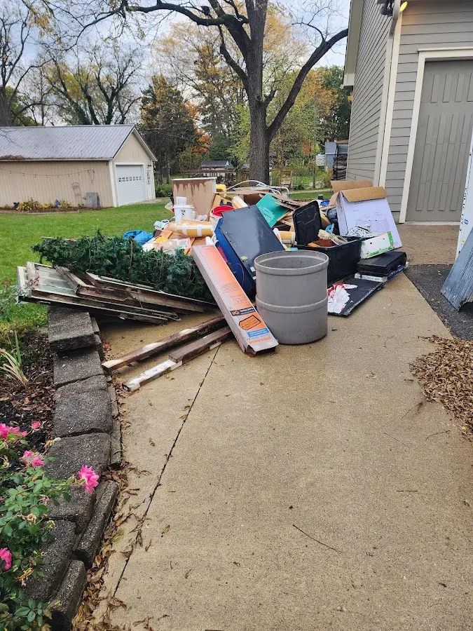 Dumpster being loaded with debris for Roofing Dumpster Rental in Long Lake